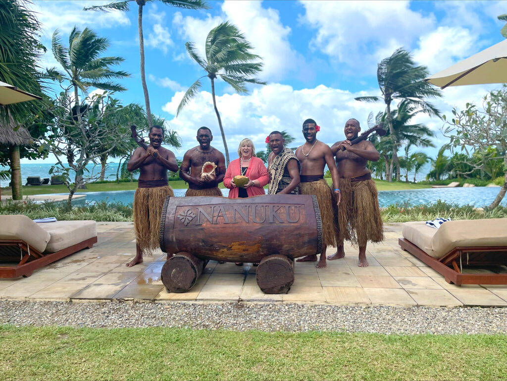 Fijian welcome committee smiles on a beach with Doni Rasmussen