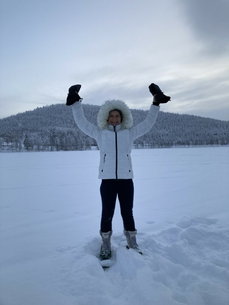 Murielle Blanchard stands with her hands up on the plains of Lapland My Finnish Lapland Christmas Adventure