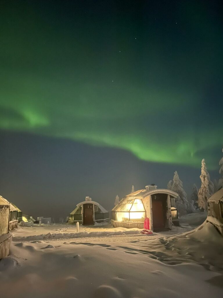 The Northern Lights over glass igloo